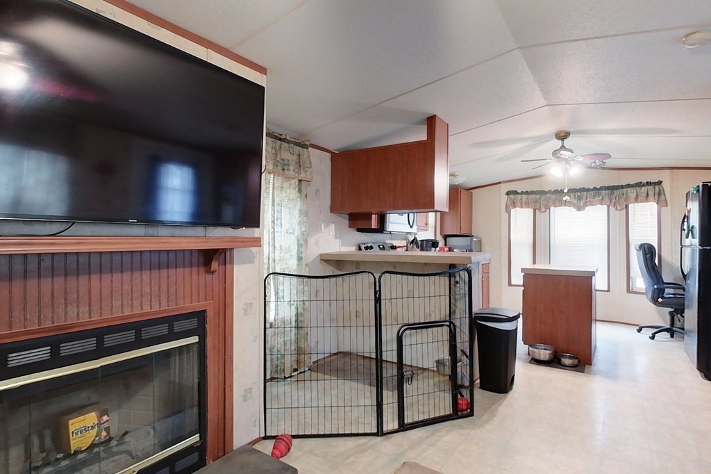 11 Groton School Road, Unit 2 Ayer, MA 01432 - Photo 7 of 14 a kitchen with table chairs cabinets and appliances