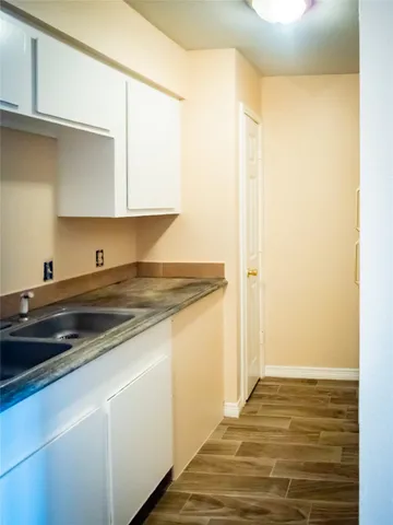 a kitchen with a sink and cabinets