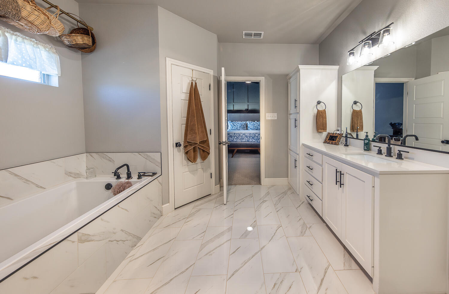 4416 140th Street Lubbock, TX 79424 - Photo 18 of 36 a spacious bathroom with a tub sink and mirror