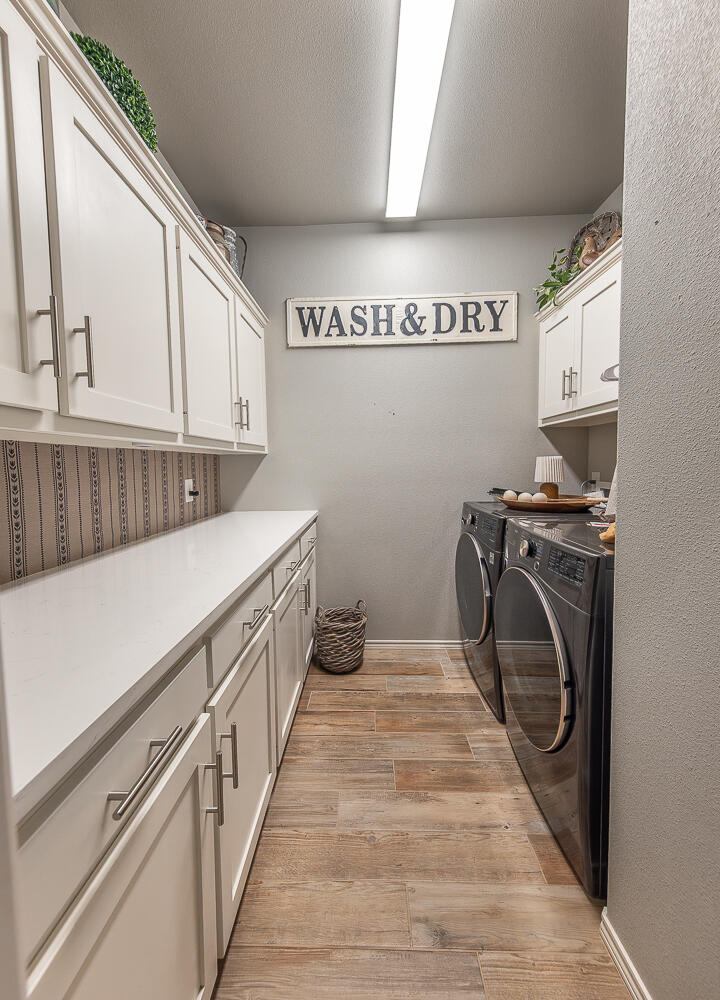 4416 140th Street Lubbock, TX 79424 - Photo 19 of 36 a utility room with sink dryer and washer