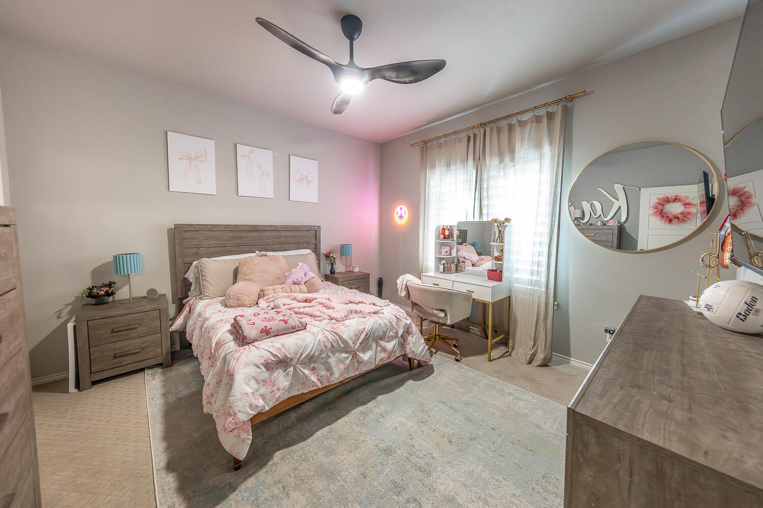 4416 140th Street Lubbock, TX 79424 - Photo 26 of 36 a bedroom with a large bed and a chandelier