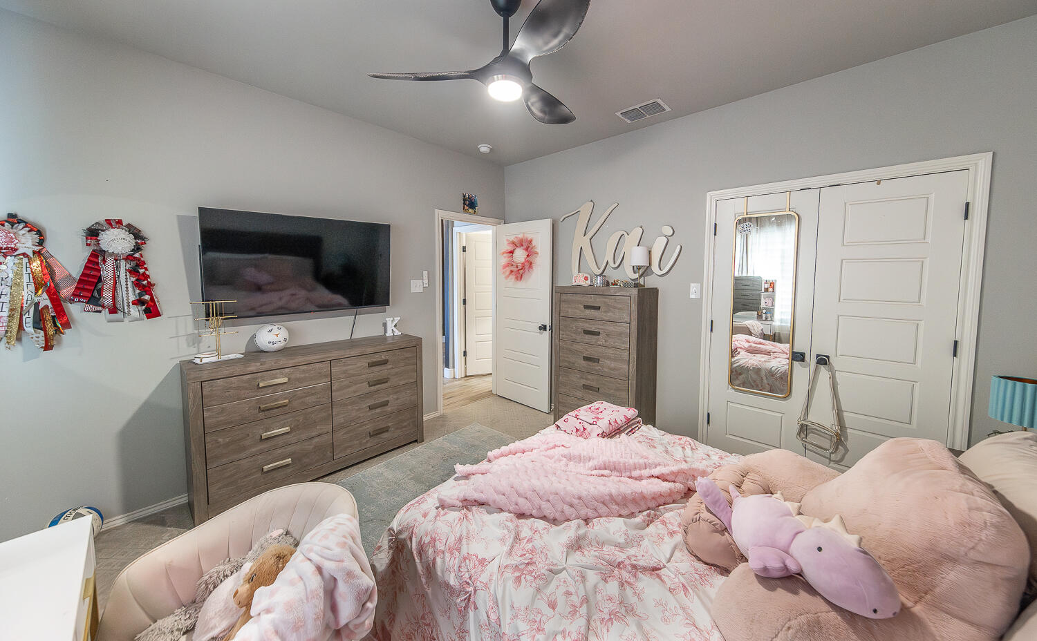 4416 140th Street Lubbock, TX 79424 - Photo 27 of 36 a bedroom with a bed and a flat screen tv