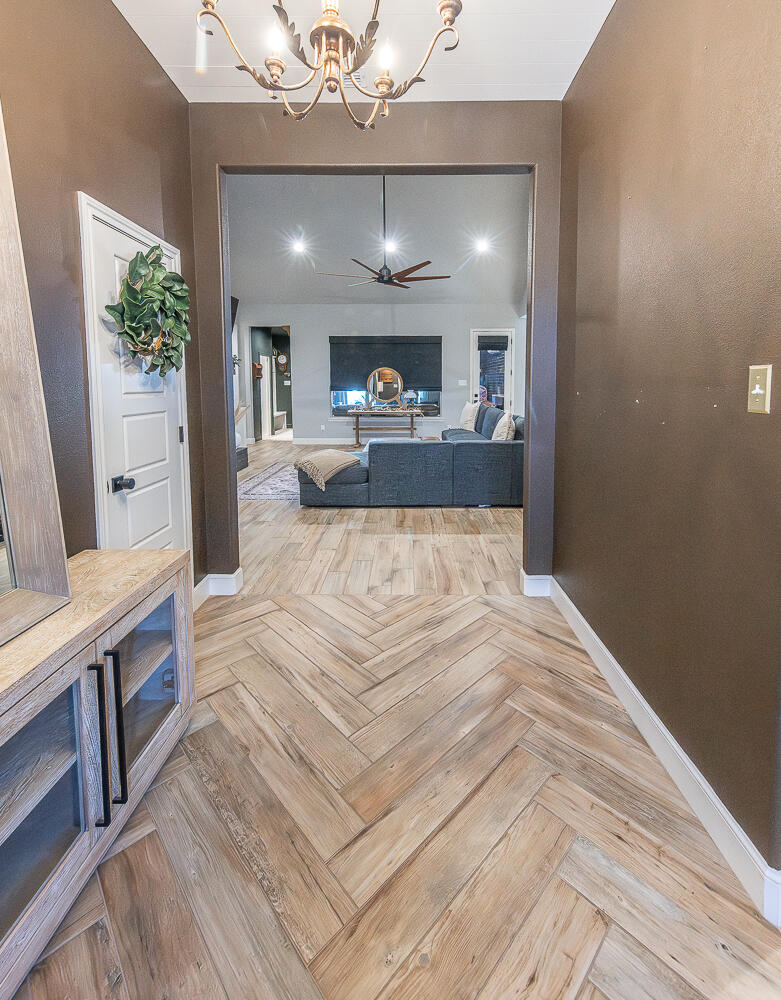 4416 140th Street Lubbock, TX 79424 - Photo 4 of 36 a view of a living room and kitchen with wooden floor
