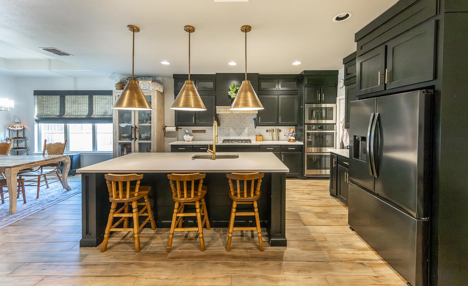 4416 140th Street Lubbock, TX 79424 - Photo 9 of 36 a kitchen with stainless steel appliances granite countertop a kitchen island a table and chairs