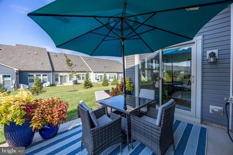 1008 Campbell Way Hatfield, PA 19440 - Photo 30 of 33 a view of a patio with couches table and chairs under an umbrella