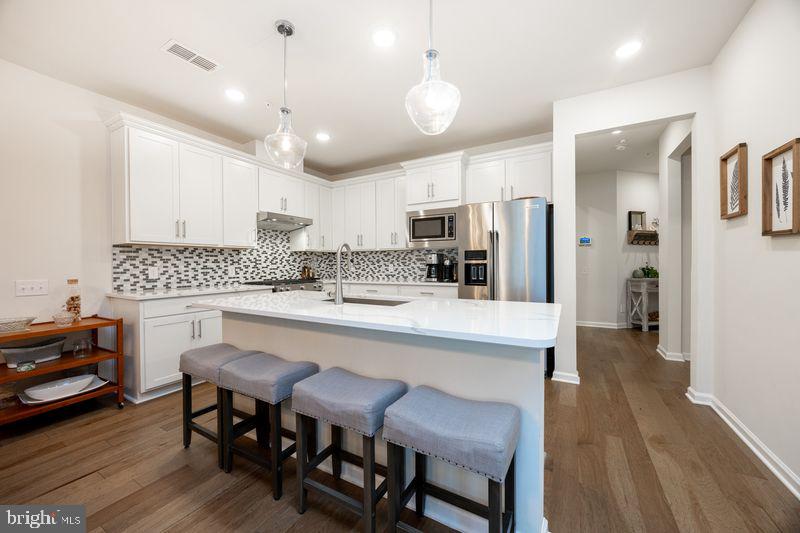 1008 Campbell Way Hatfield, PA 19440 - Photo 10 of 33 a kitchen with a dining table chairs refrigerator and microwave