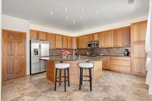a kitchen with refrigerator and cabinets
