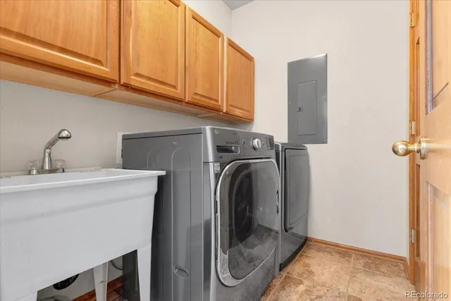 a utility room with sink dryer and washer