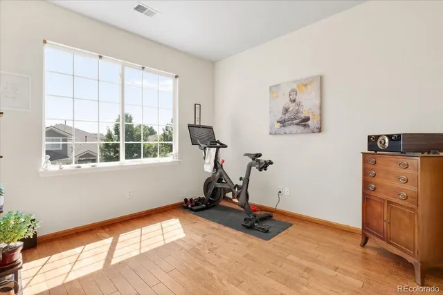 a view of a room with gym equipment and windows