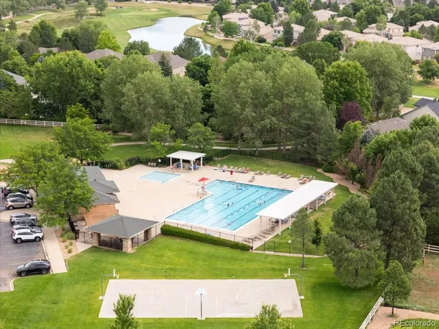 an aerial view of a house with yard swimming pool and outdoor seating