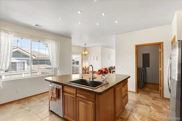 a kitchen with a sink and large window