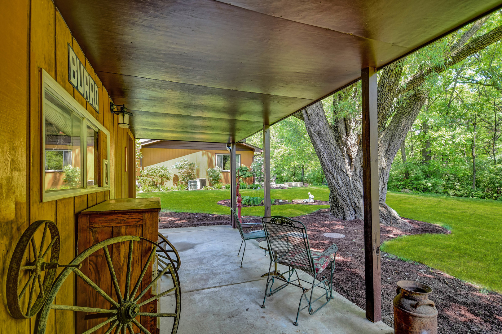 17342 Bluff Road Lemont, IL 60439 - Photo 31 of 32 a view of a patio with table and chairs under an umbrella with a large tree