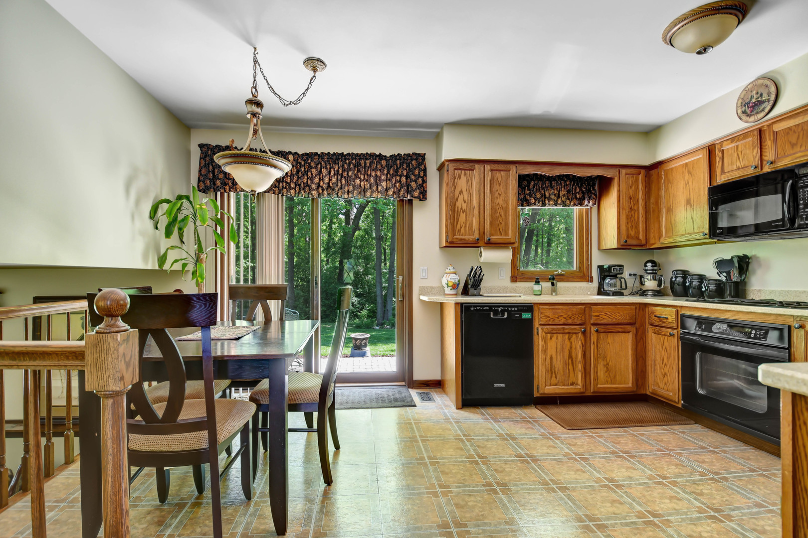 17342 Bluff Road Lemont, IL 60439 - Photo 8 of 32 a kitchen with a table chairs sink and cabinets