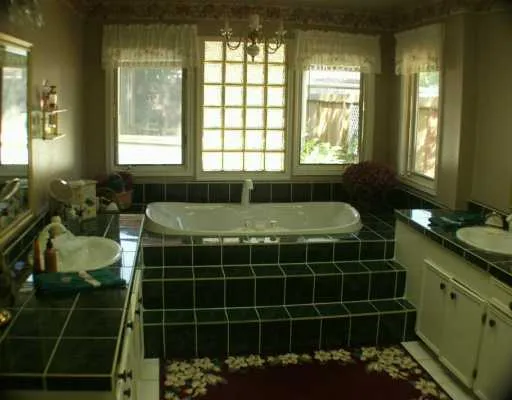 a bathroom with a double vanity sink and a bathtub