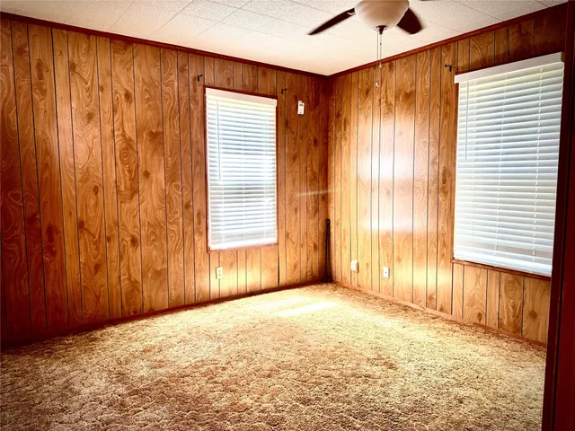 a very nice looking bedroom with a large window