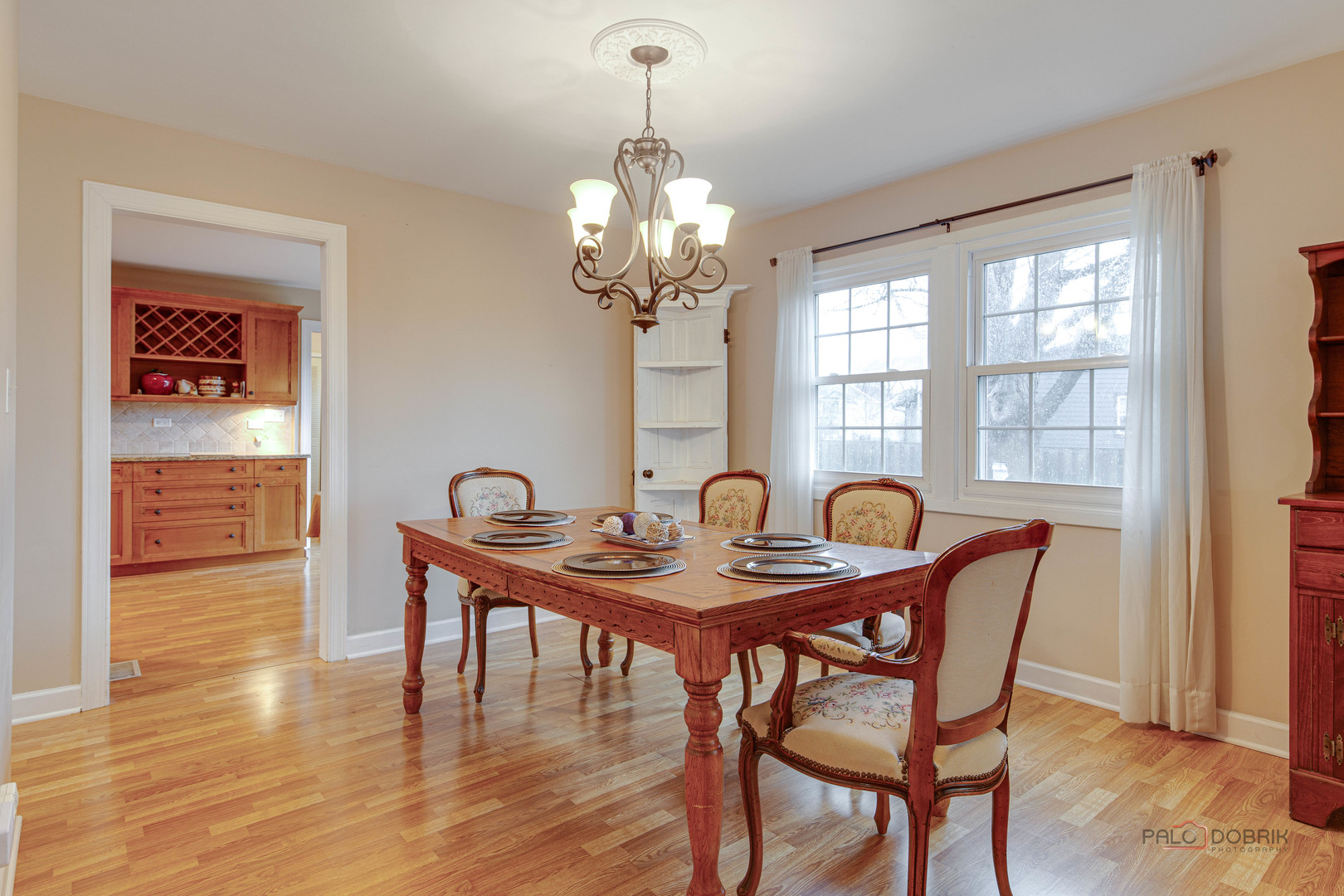 441 Arbor Gate Lane Buffalo Grove, IL 60089 - Photo 11 of 29 a dining room with furniture a chandelier and wooden floor
