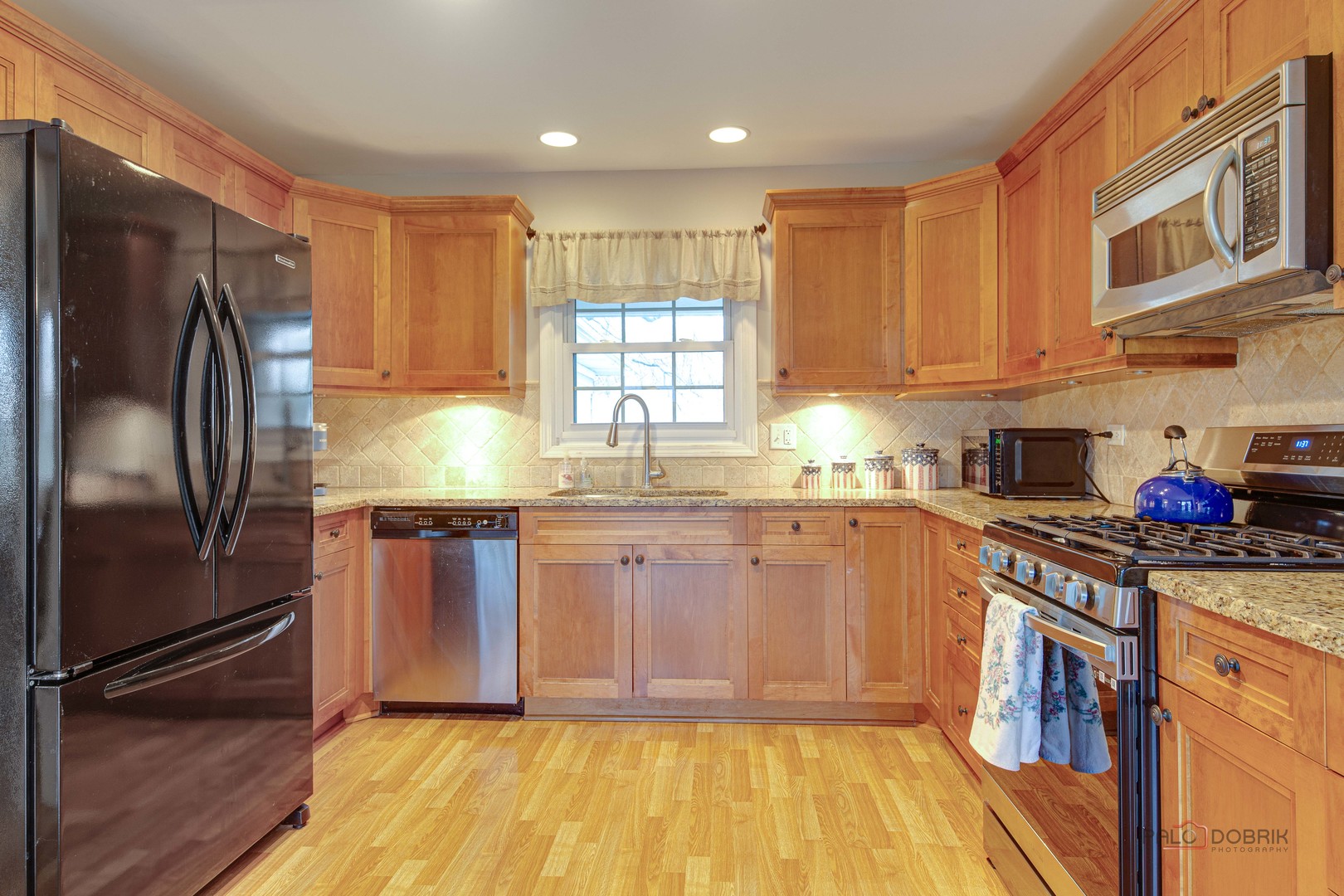 441 Arbor Gate Lane Buffalo Grove, IL 60089 - Photo 13 of 29 a kitchen with stainless steel appliances granite countertop a refrigerator sink and stove