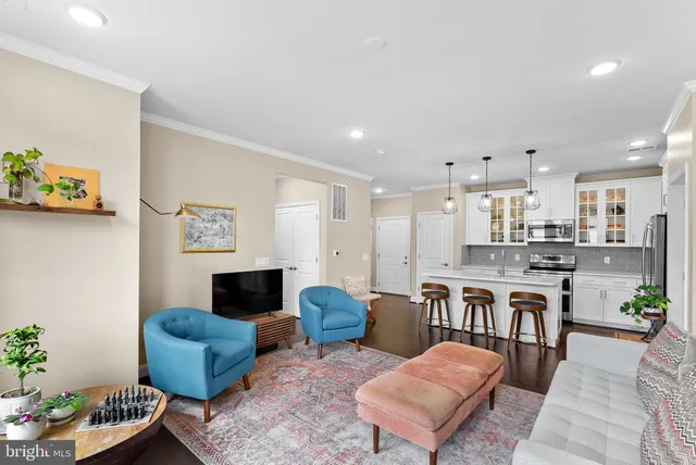a living room with furniture kitchen view and a fireplace