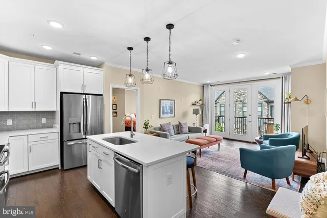 a kitchen that has a lot of cabinets a sink and appliances in it