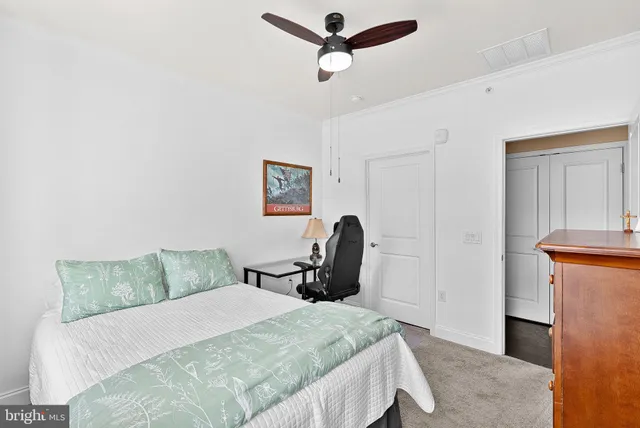 a bedroom with a bed and a dresser