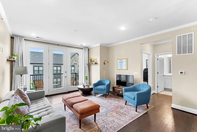 a living room with furniture or couch and a wooden floor