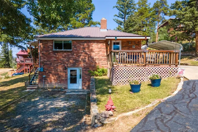 a front view of a house with outdoor seating