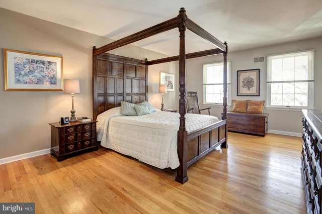 a spacious bedroom with a bed and a window