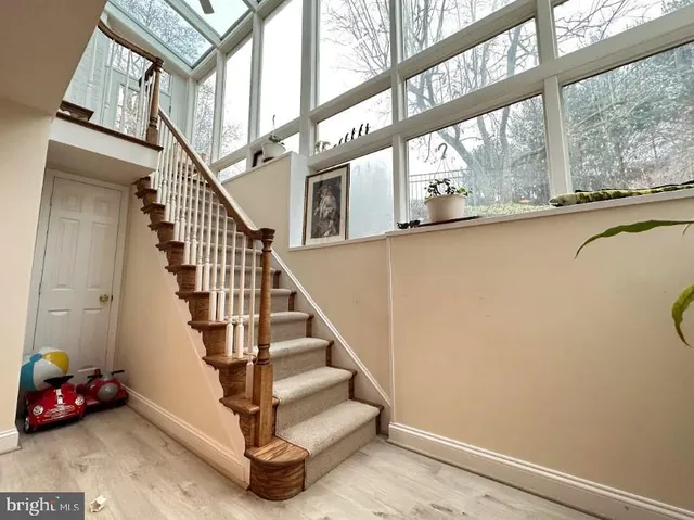 a view of entryway and hall with wooden floor