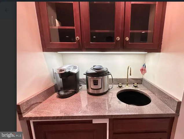 a kitchen with a sink a stove and cabinets
