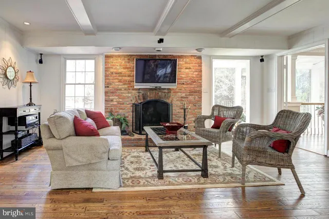 a living room with fireplace furniture and a fireplace