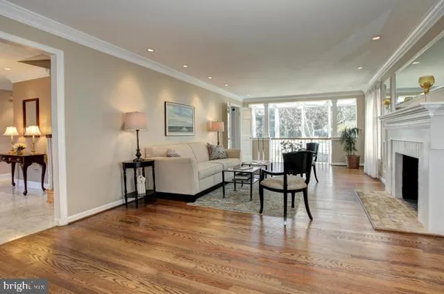 a living room with furniture a fireplace and a table