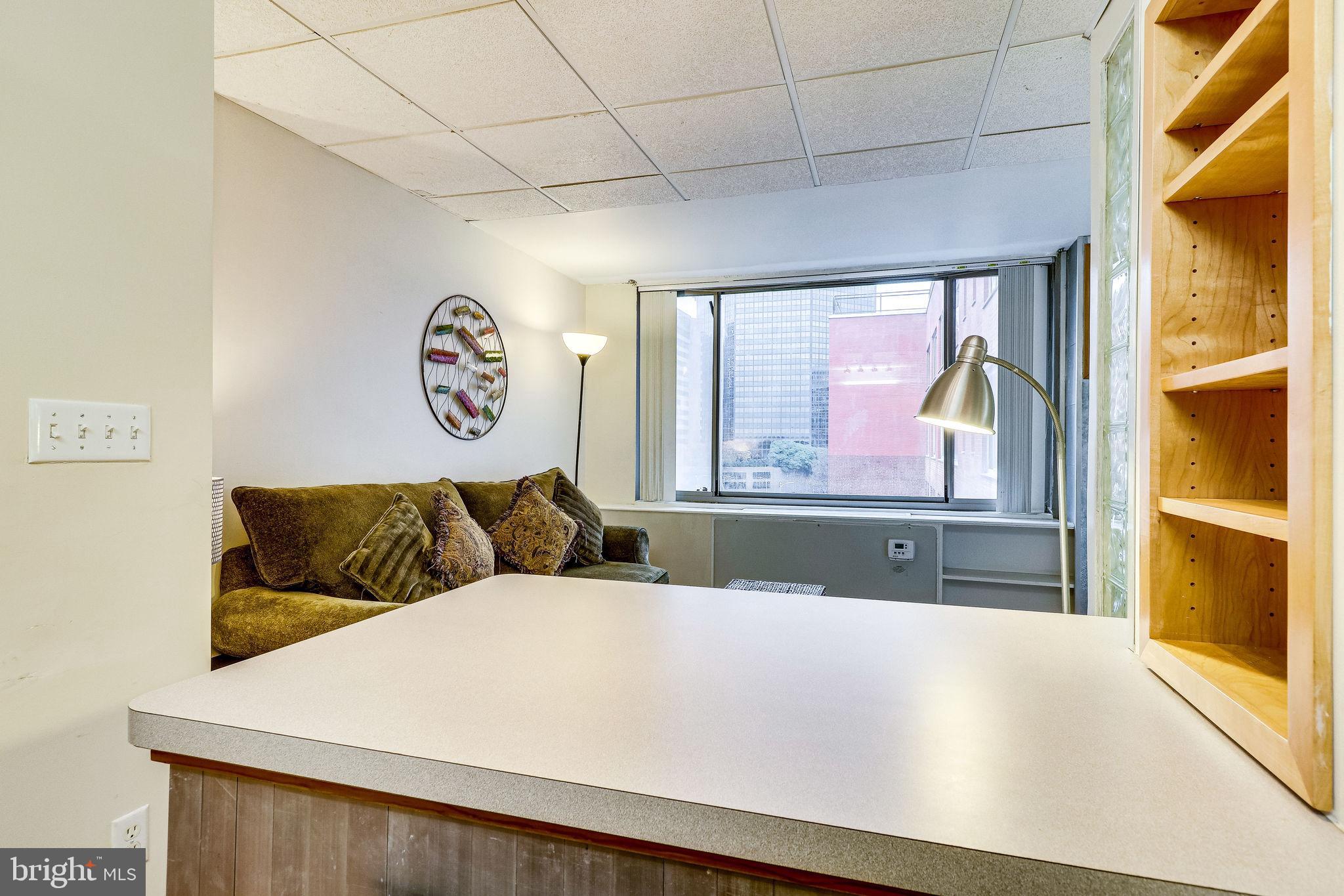 1111 Arlington Boulevard, Unit 812 Arlington, VA 22209 - Photo 11 of 37 a bed sitting in a bedroom next to a window