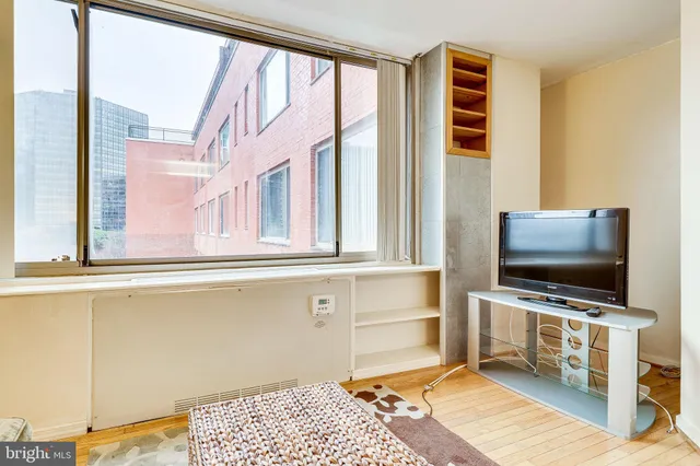 a living room with a couch and a painting on the wall
