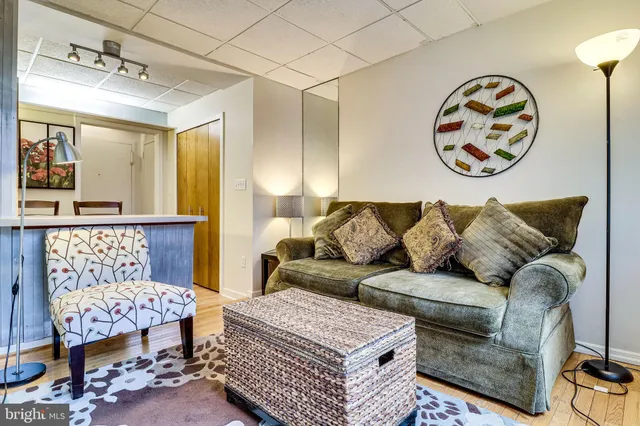 a living room with a couch and chandelier