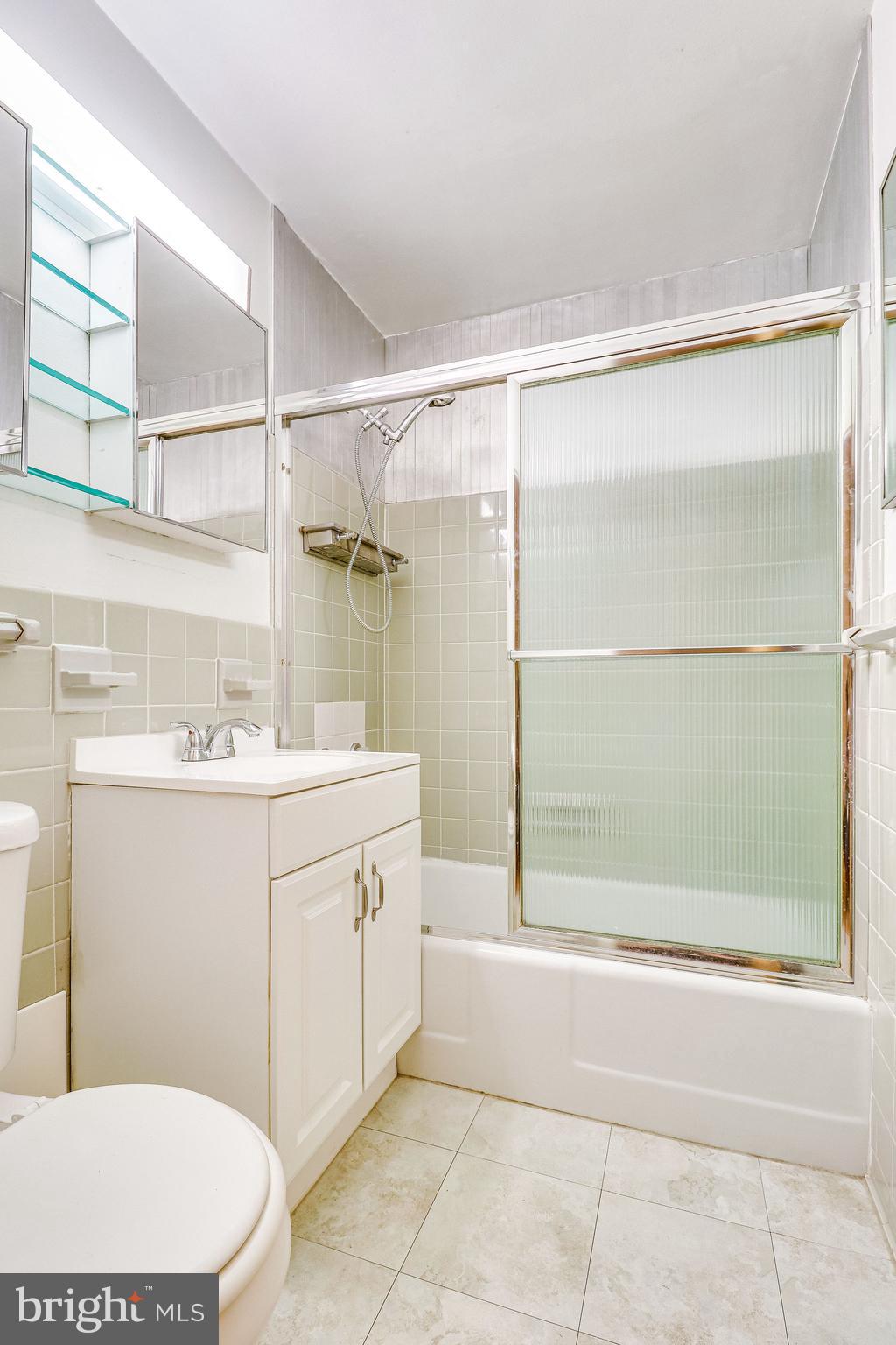 1111 Arlington Boulevard, Unit 812 Arlington, VA 22209 - Photo 31 of 37 a bathroom with a sink a toilet and shower