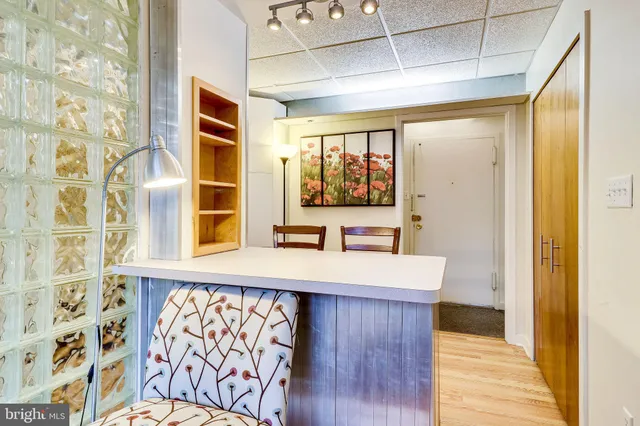 a view of a kitchen with wooden floor and a window
