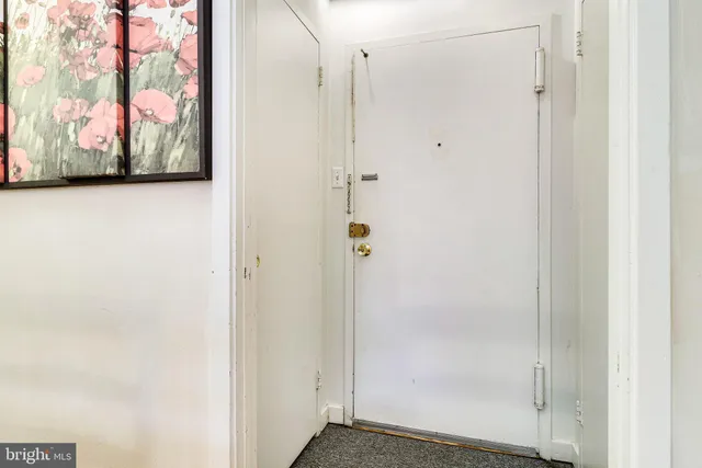 a view of a hallway with paintings on the wall