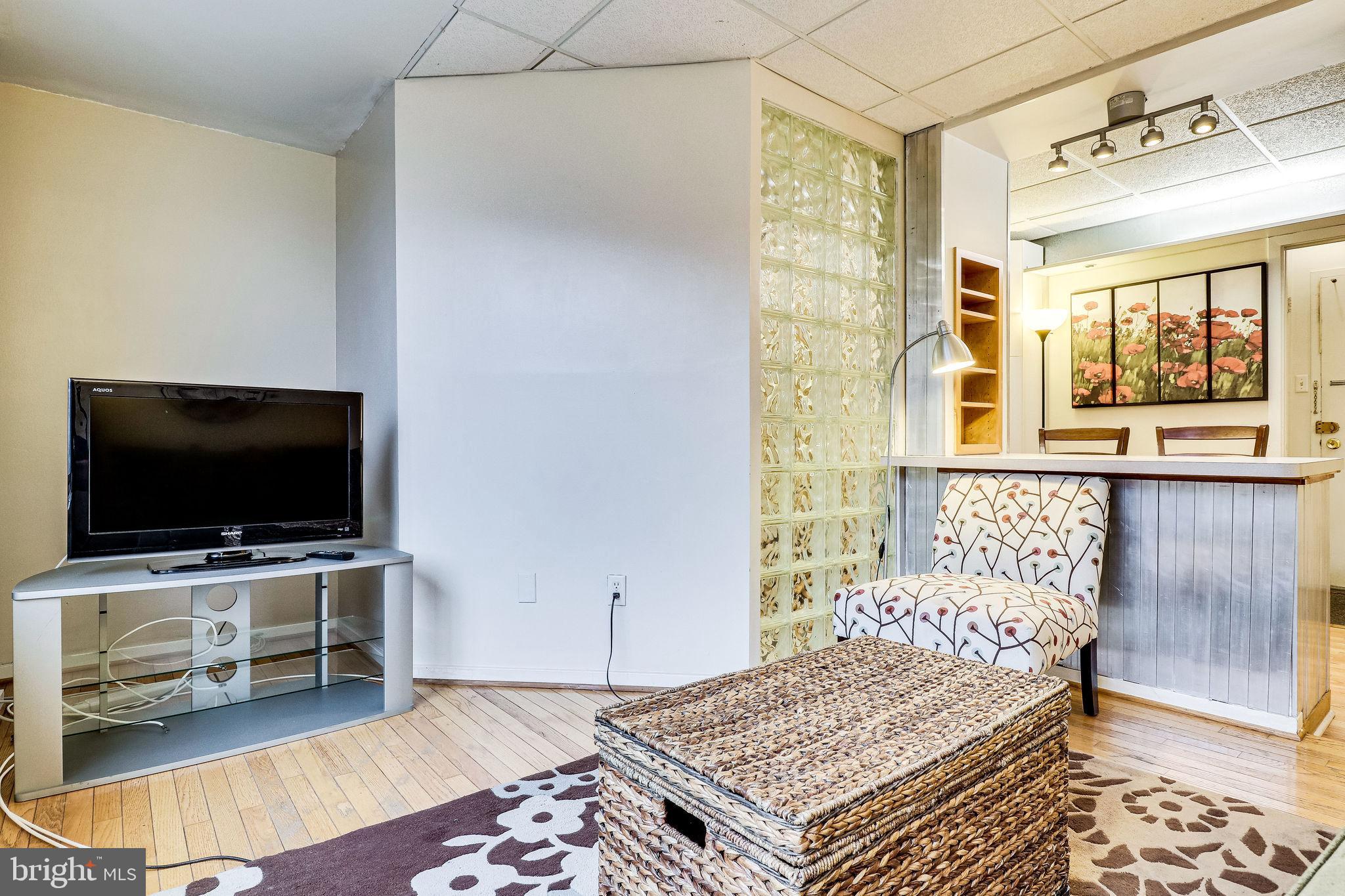 1111 Arlington Boulevard, Unit 812 Arlington, VA 22209 - Photo 9 of 37 a bedroom with a bed and flat screen tv