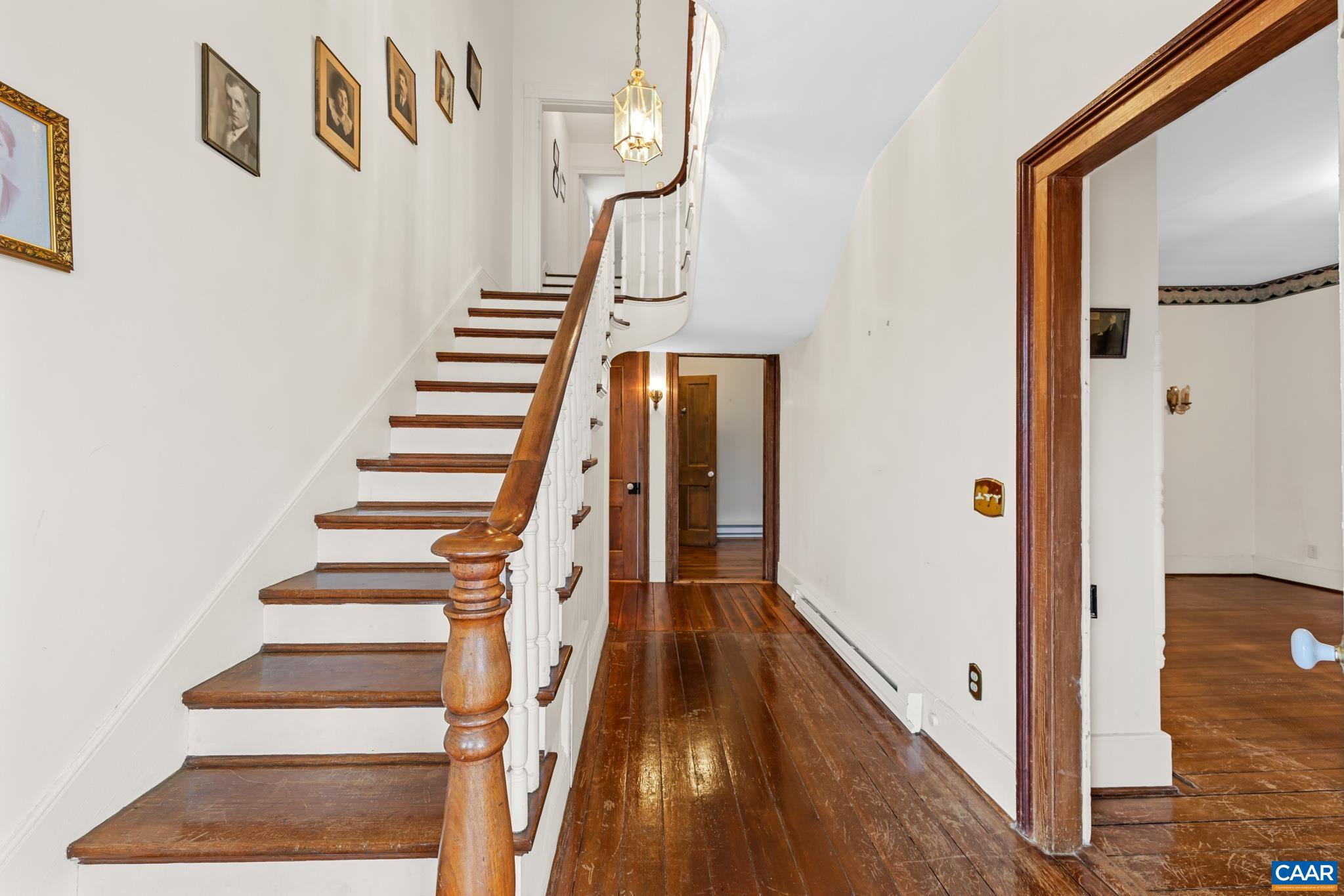 9451 Black Walnut Run Road Rhoadesville, VA 22542 - Photo 14 of 72 a view of a hallway with wooden floor and staircase