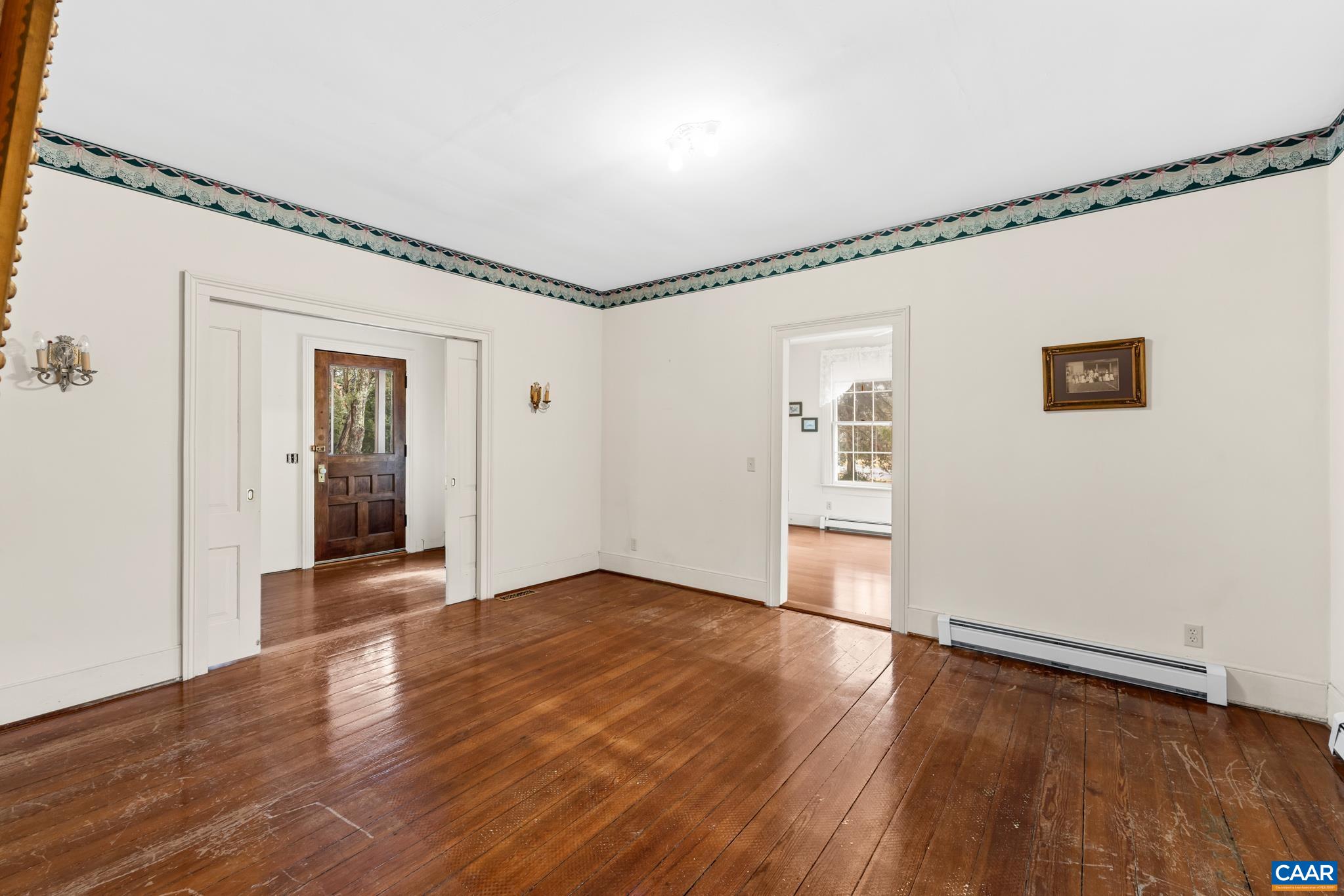 9451 Black Walnut Run Road Rhoadesville, VA 22542 - Photo 17 of 72 a view of an empty room with wooden floor and a window