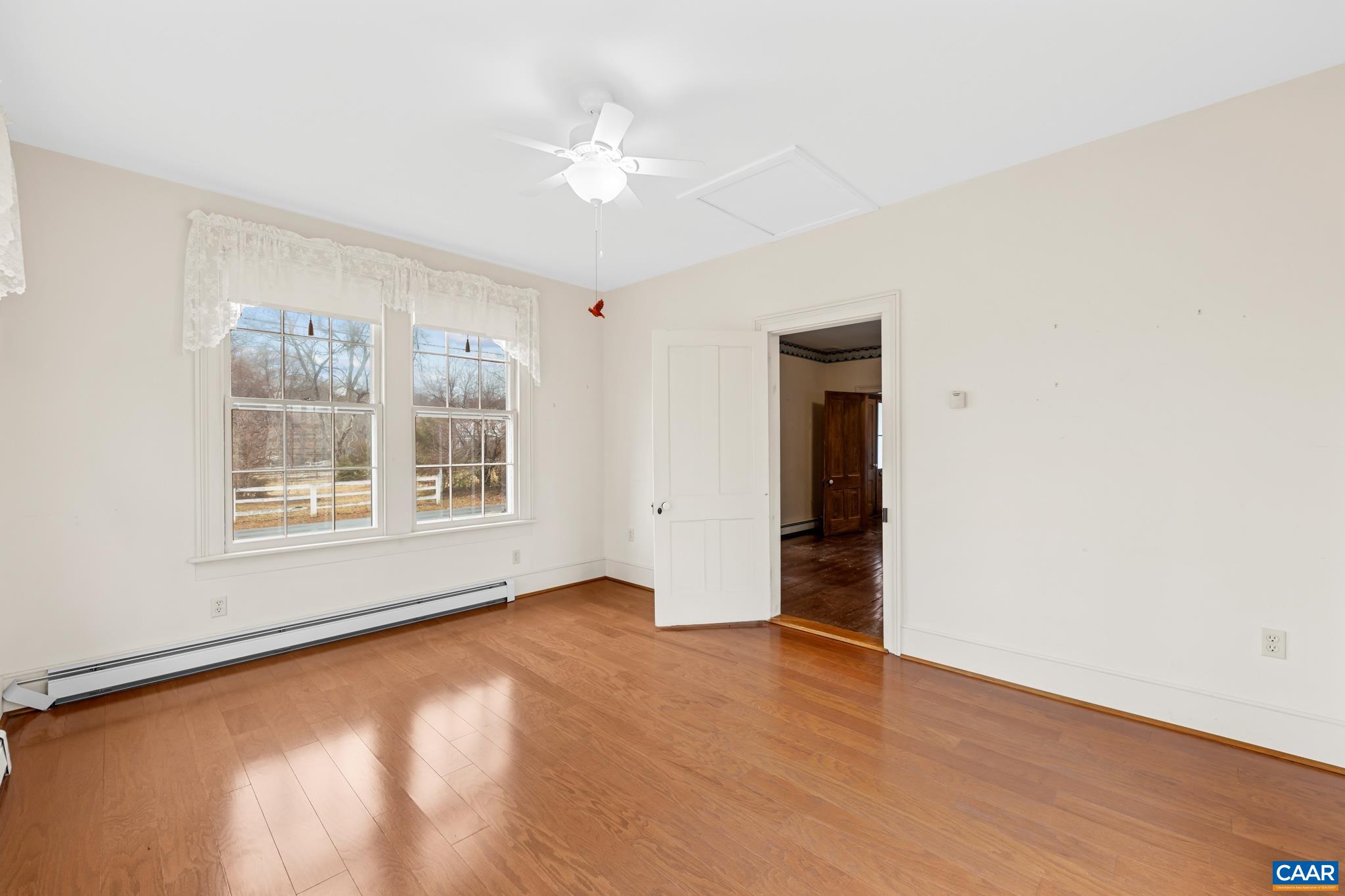 9451 Black Walnut Run Road Rhoadesville, VA 22542 - Photo 20 of 72 a view of an empty room with a window and wooden floor