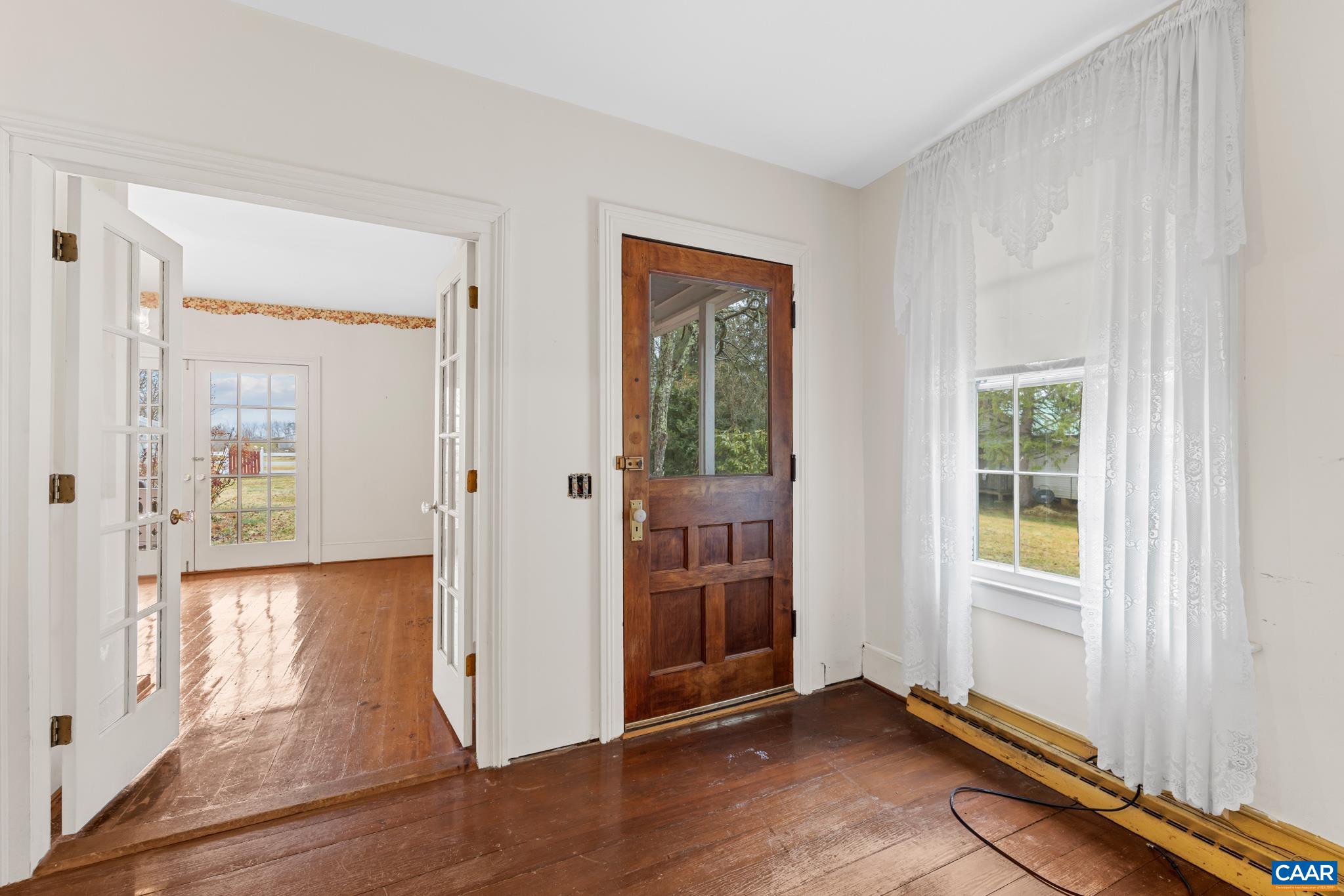 9451 Black Walnut Run Road Rhoadesville, VA 22542 - Photo 21 of 72 an empty room with wooden floor and windows