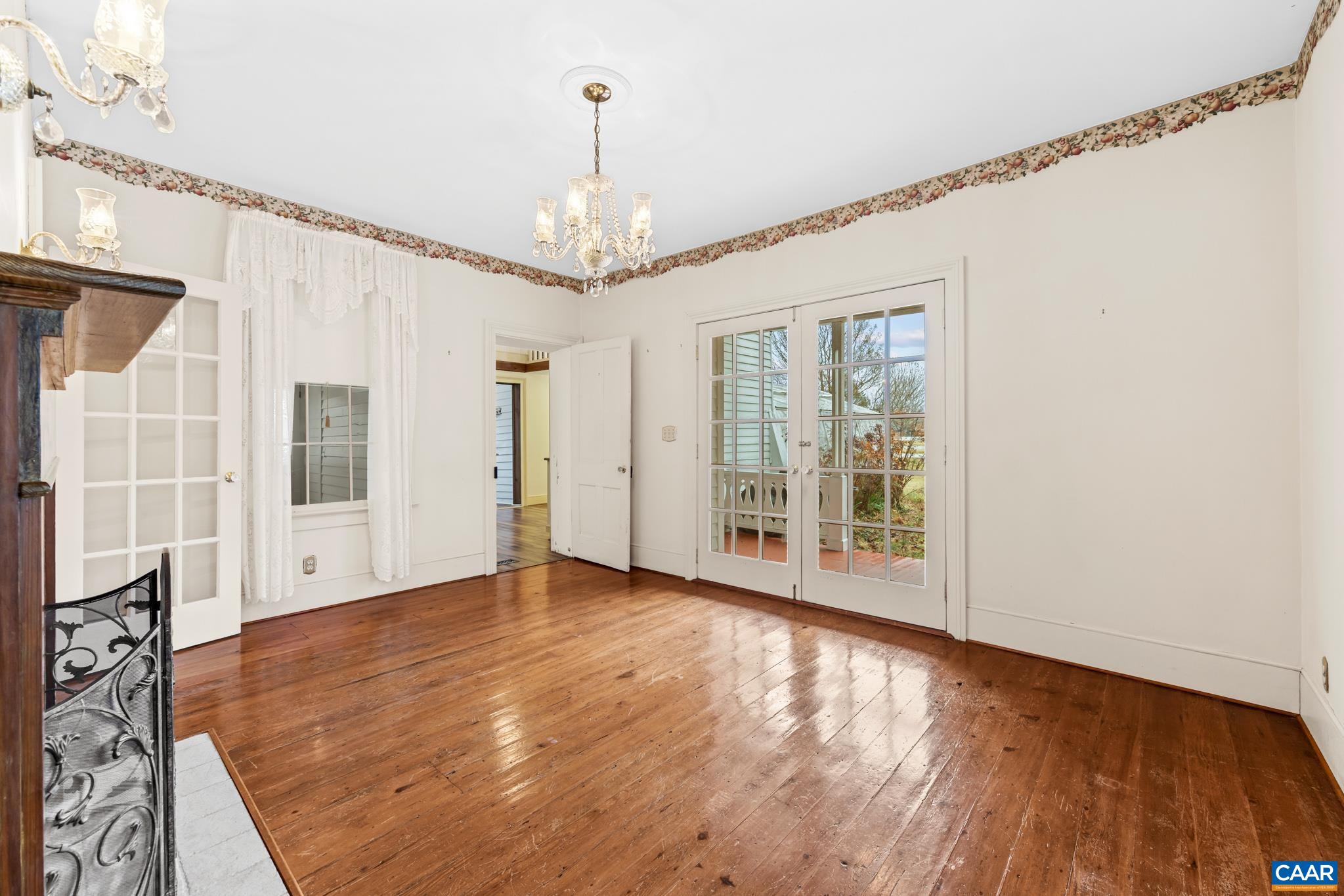 9451 Black Walnut Run Road Rhoadesville, VA 22542 - Photo 23 of 72 a view of an empty room with wooden floor and a window