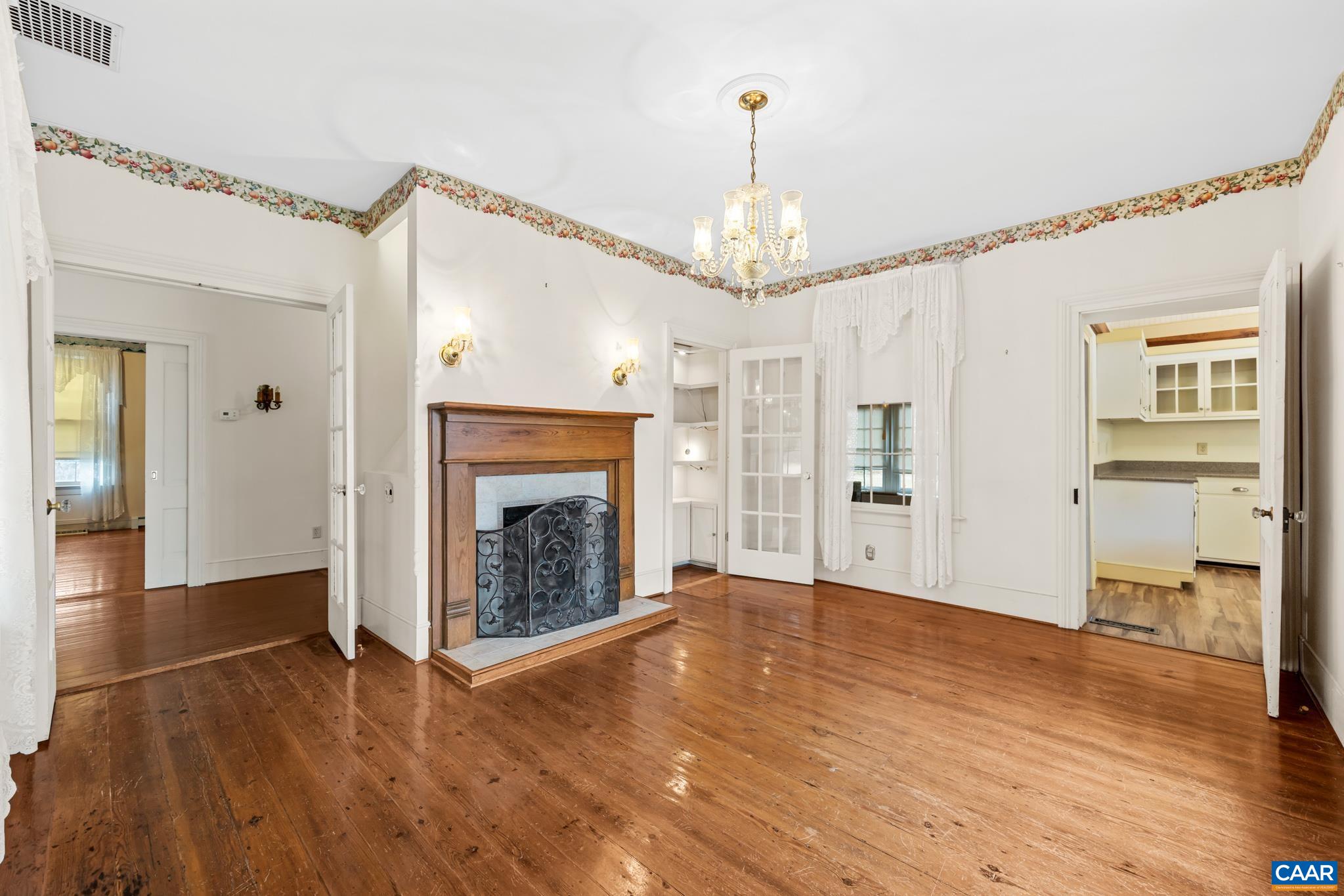 9451 Black Walnut Run Road Rhoadesville, VA 22542 - Photo 24 of 72 a view of an empty room with wooden floor fireplace and a window