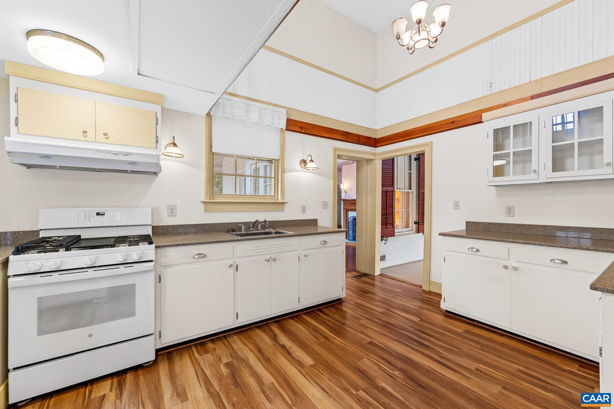 9451 Black Walnut Run Road Rhoadesville, VA 22542 - Photo 30 of 72 a kitchen with granite countertop white cabinets and white appliances