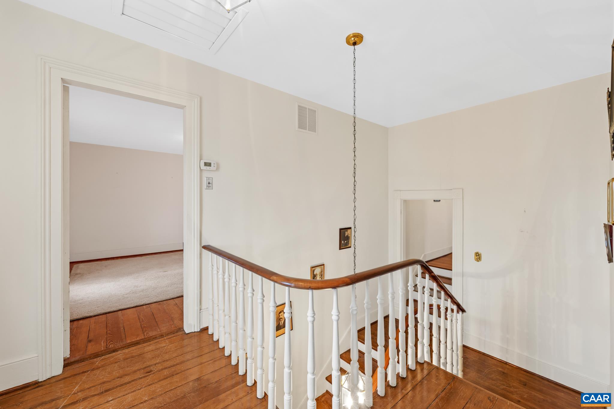 9451 Black Walnut Run Road Rhoadesville, VA 22542 - Photo 41 of 72 a view of a hallway with wooden floor and staircase