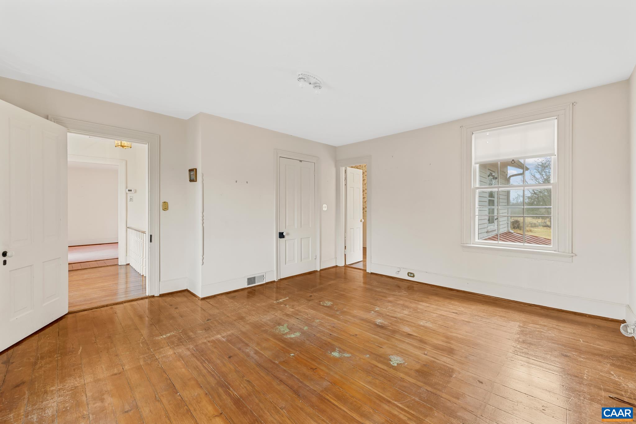 9451 Black Walnut Run Road Rhoadesville, VA 22542 - Photo 45 of 72 a view of an empty room with wooden floor and a window