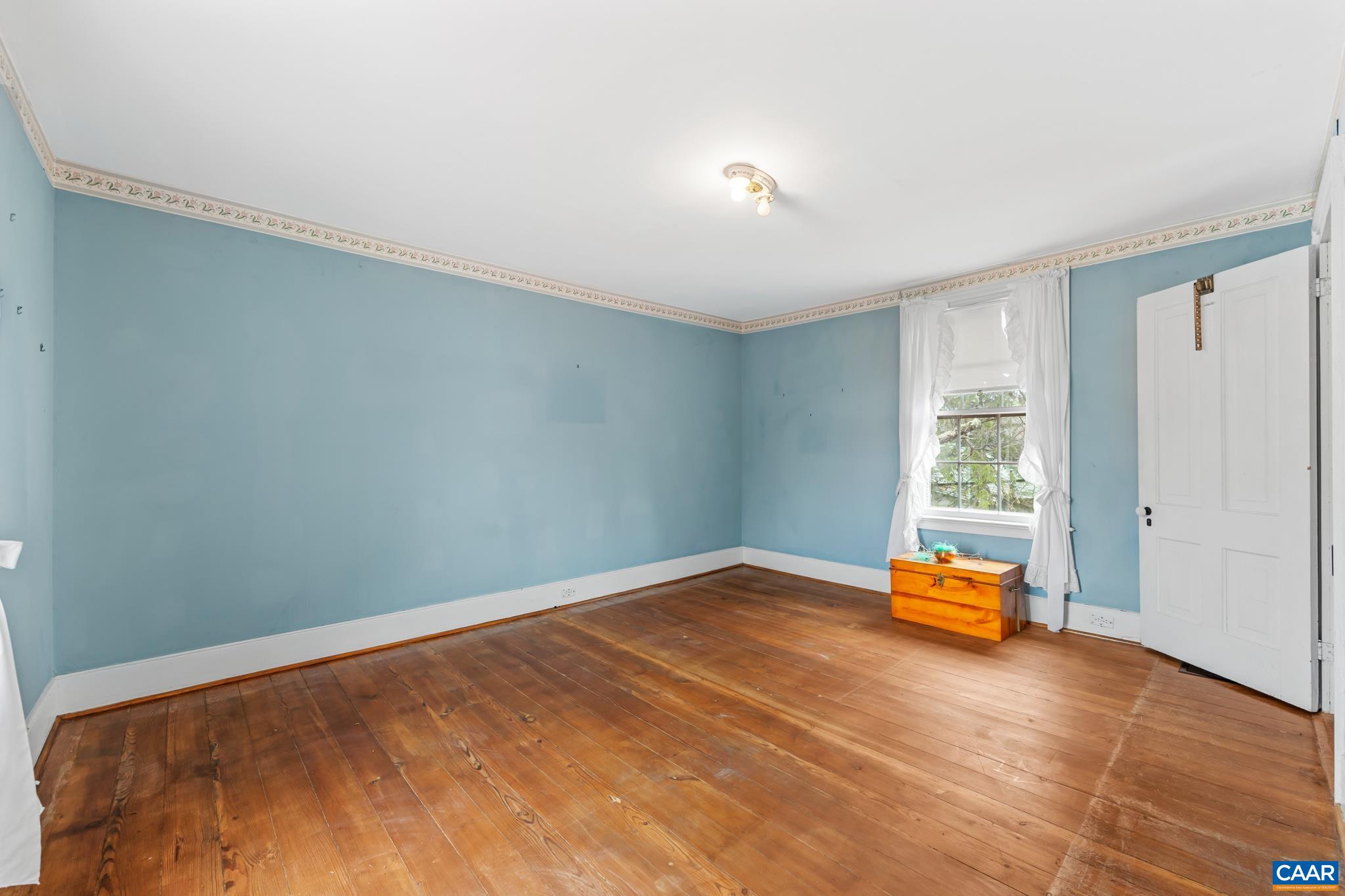 9451 Black Walnut Run Road Rhoadesville, VA 22542 - Photo 48 of 72 a view of a room with a flat tv screen and a window