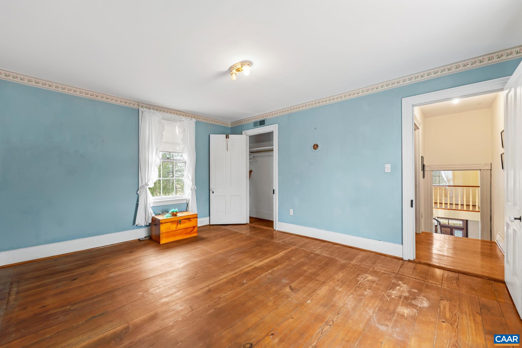 9451 Black Walnut Run Road Rhoadesville, VA 22542 - Photo 49 of 72 a view of a livingroom with wooden floor and a couch