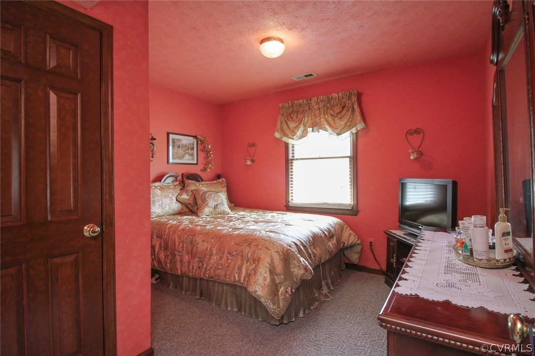 1500 Austin Road Chester, VA 23836 - Photo 20 of 30 a bedroom with a bed table chair and a window